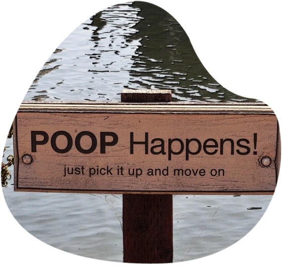 A sign that says poop happens just pick it up and move on.
